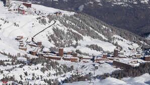 A snow-covered mountain resort with multiple buildings, ski slopes, and a ski lift. - Cozy studio with balcony and Mont-Blanc view in La Plagne (La Plagne)