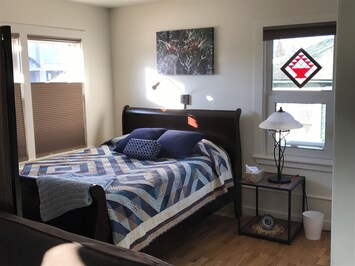 Queen sled bed for two guests with handmade quilt