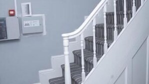 A staircase with white railings and striped carpeted steps. - Spring Bank ApartHotel (Preston)