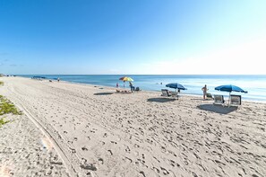 Rannalla, aurinkotuoleja, rantapyyhkeitä