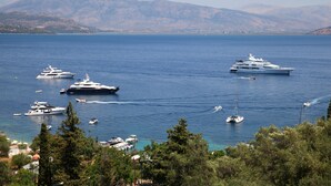 A marina with several yachts and boats, surrounded by hills and trees. - Villa Agni, Contemporary villa in excellent location just 200 meters from Agni Beach (Agni Beach)