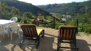 A terrace with two chairs and a table, overlooking a valley with houses and greenery. - Pretty holiday cottage with private pool, fantastic views sleeps 6, Arganil 7kms (Arganil)