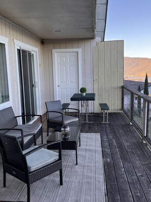 Relax on the balcony with a set of comfortable chairs and a scenic view.