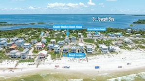 An aerial view of a coastal resort with beach houses, a grocery/marine supply area, and beach access. - Steps From The Oceanfront! Pool, Pet Friendly, Wifi, king beds! WEEKLY DISCOUNTS (Cape San Blas)