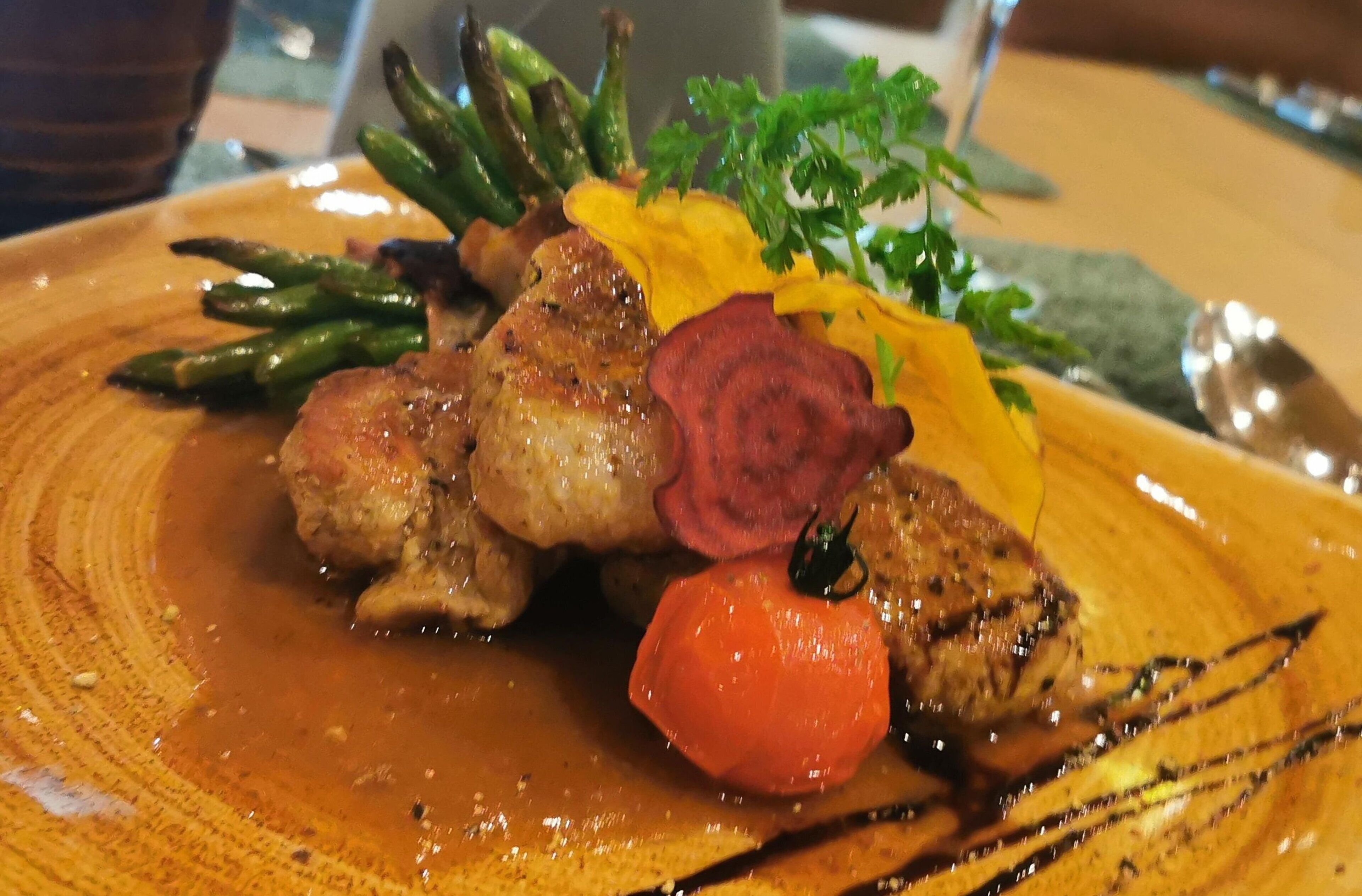 A plate of food with various vegetables and a sauce.