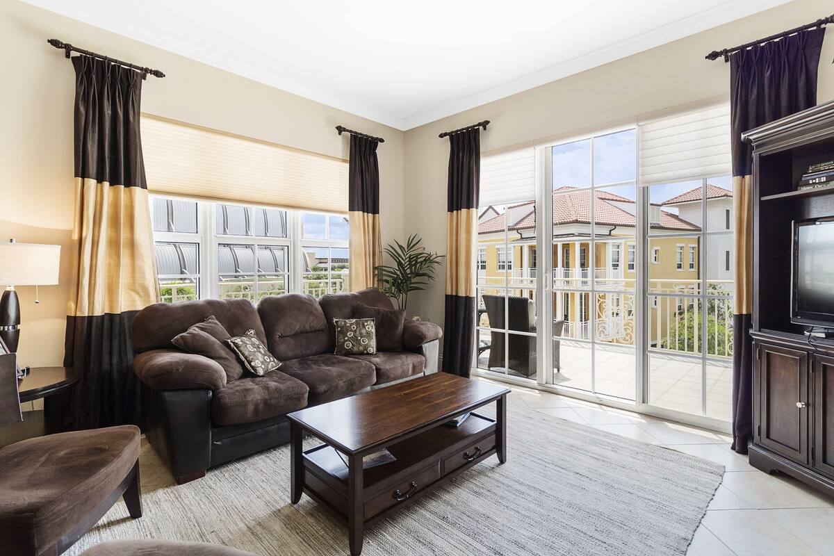 A living room with a sofa, coffee table, and TV stand.