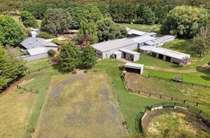 Set amidst lush greenery, this modern property offers a spacious grassy area and a fenced section for recreational activities.