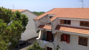 A two-story building with a tiled roof, a balcony, and a car parked in the driveway. - Diamond holiday 2019 La Casa Di Fra  (Diamante)