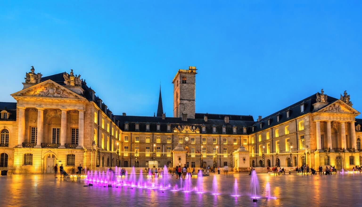 A historic building with classical architecture, a central courtyard, and a tower.