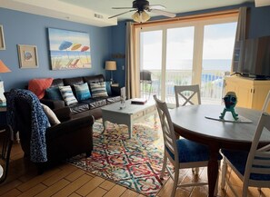 A living room with a sofa, coffee table, and chairs, a balcony with a view, and a ceiling fan. - Most Amazing Views ever in this beautiful 2 bedrm 2 bath condo in Resort area! (Tybee Island)