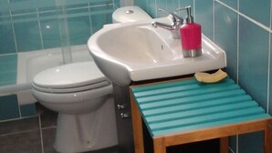 A bathroom with a toilet, bidet, and sink. - Damencourt bungalows Section Damencourt chemin de pinadiere 97160 le mold  (guadeloupe)