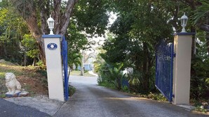 A gated entrance to Villa Indigo with a pathway leading to the property. - The Cottage at Villa Indigo 2BR/1.5BA in Exclusive Private Gated Community (Saint Thomas)