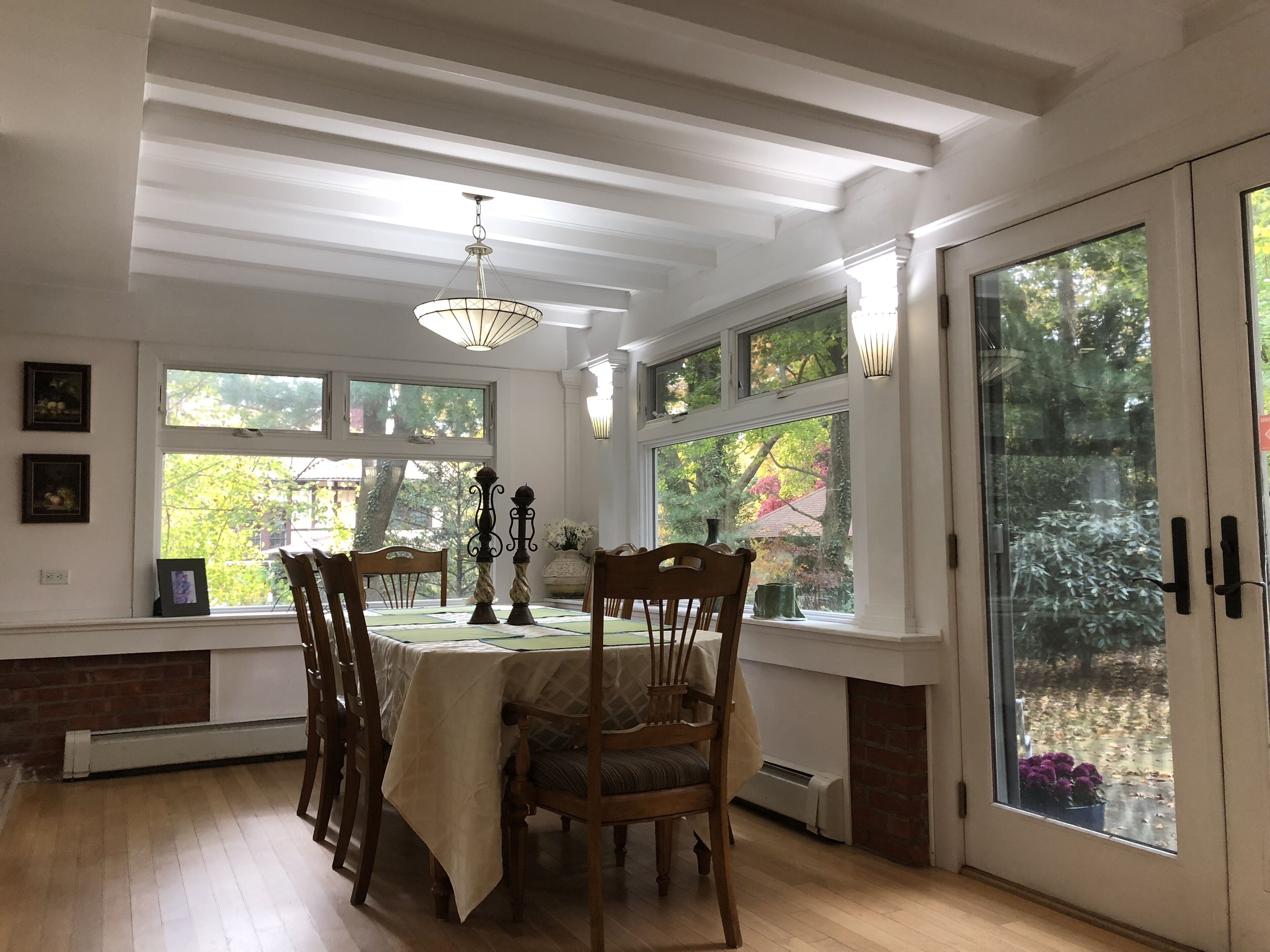 Dining Room with doors leading to the patio. Original brick and beams preserved.