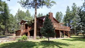 A wooden cabin with a porch, surrounded by trees. - Outdoor Fire Pit, Wildlife Watching, Monte Verde Lake Ponderosa (Angel Fire)