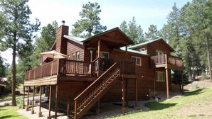 A two-story wooden cabin with a balcony and a staircase. - Outdoor Fire Pit, Wildlife Watching, Monte Verde Lake Ponderosa (Angel Fire)