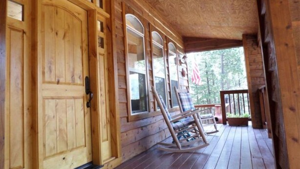 A wooden cabin with a porch, large windows, and a rocking chair. - Outdoor Fire Pit, Wildlife Watching, Monte Verde Lake Ponderosa (Angel Fire)