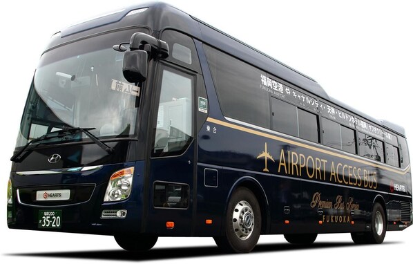 A dark blue bus with "AIRPORT ACCESS BUS" and "FUKUOKA" written on the side, indicating it is a shuttle service to Fukuoka Airport. - HEARTS Capsule Hotel & Spa HAKATA (Fukuoka)