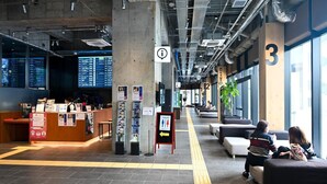 A spacious waiting area with a reception desk, seating areas, and clear signage for facilities like toilets and family amenities. - HEARTS Capsule Hotel & Spa HAKATA (Fukuoka)
