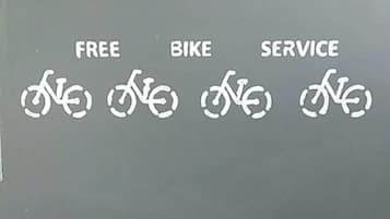 A wall with the words "FREE," "BIKE," and "SERVICE" and corresponding bicycle symbols.