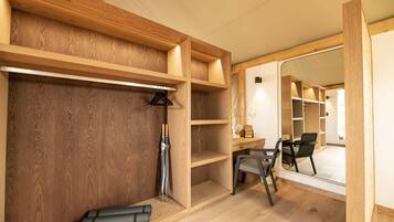 A room with wooden shelving, a desk, and a chair.