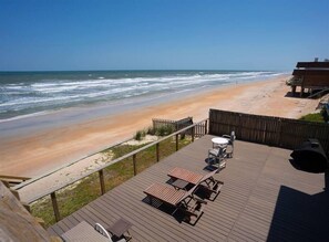Enjoy the ocean view from the deck, where tables and chairs invite relaxation.