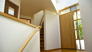 A staircase with wooden handrails leading to a landing.
