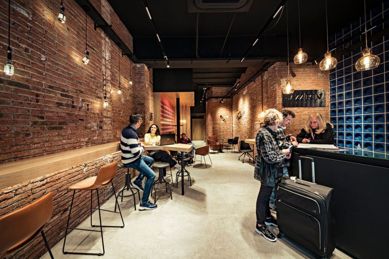 A modern interior with brick walls, hanging pendant lights, and a bar area.