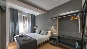 A modern hotel room with a large bed, bedside tables, a wardrobe, and a window with curtains. - Cool Jazz 44 - Habitat Apartments (Barcelona)