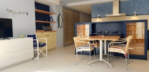 Una cocina moderna con comedor, que incluye un televisor, armarios de madera y una mesa de comedor con sillas.