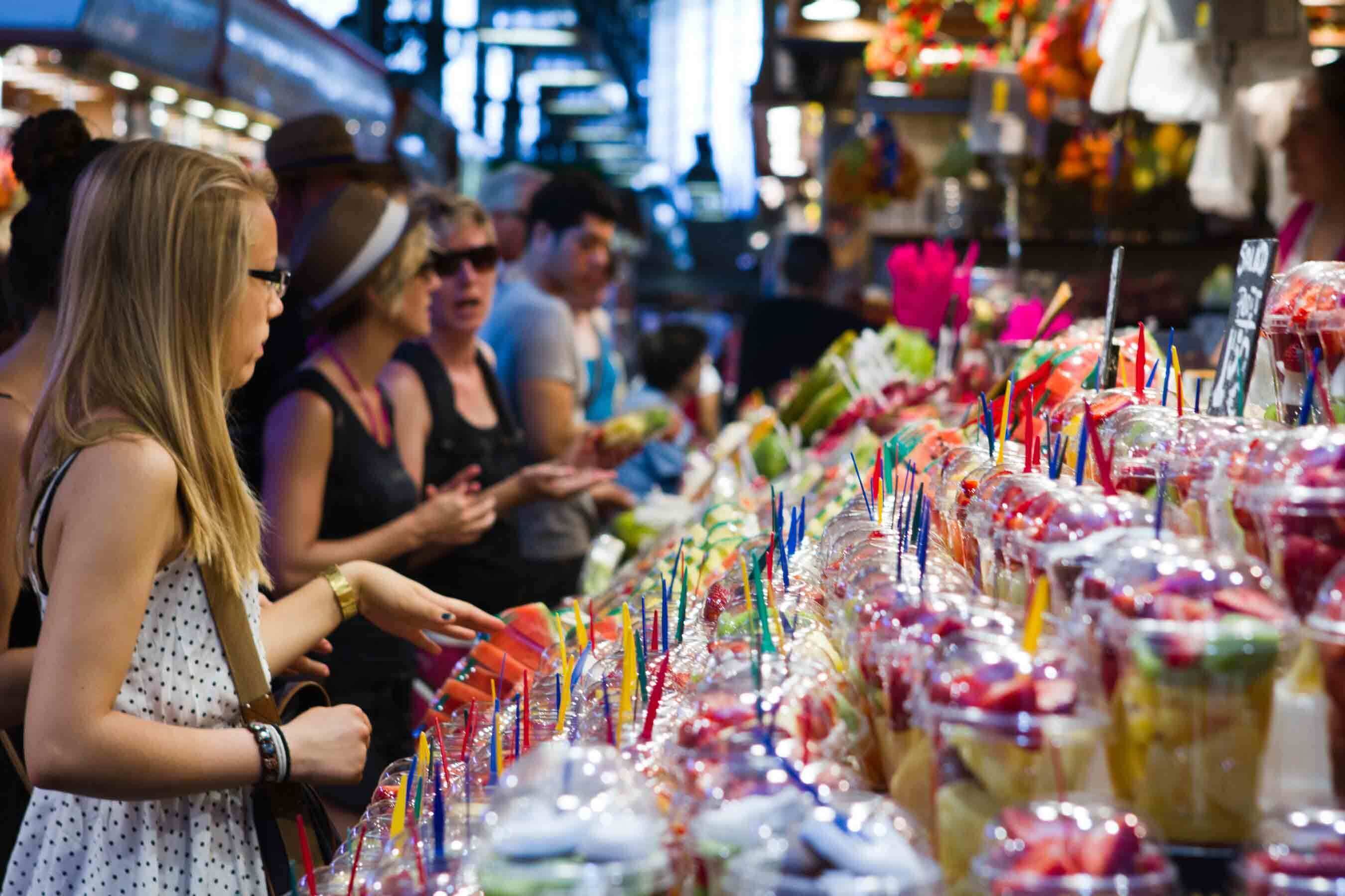 Un étal de marché proposant divers produits alimentaires et boissons.