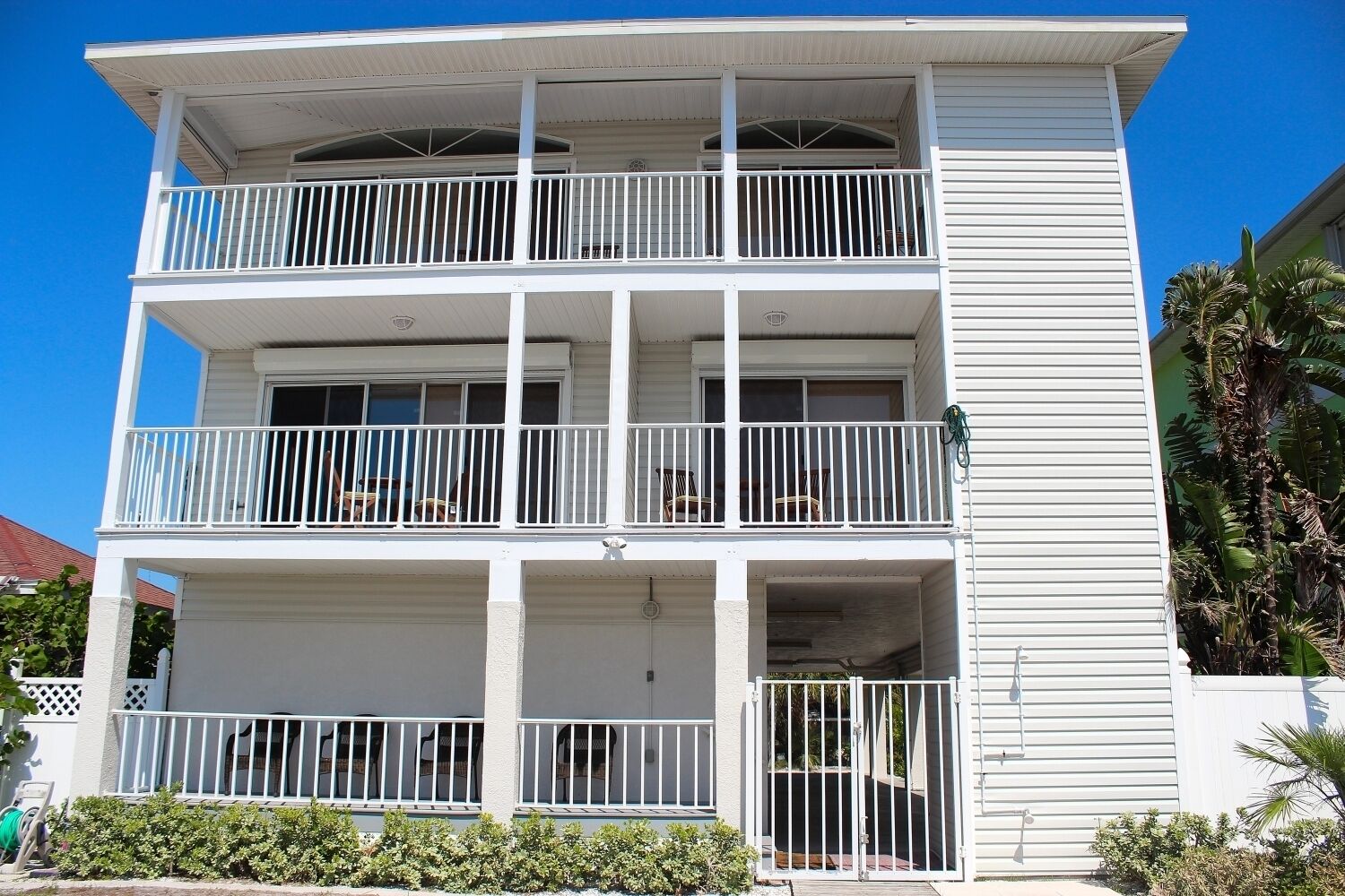 Un immeuble à plusieurs étages doté de balcons et d’une entrée sécurisée par un portail.