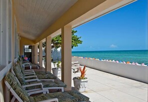 Relax in style with comfortable lounge chairs overlooking the ocean and beach.