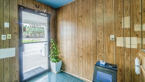 A wooden interior with a reception desk, a potted plant, and a sign reading "LOBBY". - OYO Budget Inn Falfurrias Hwy 281 (Falfurrias)