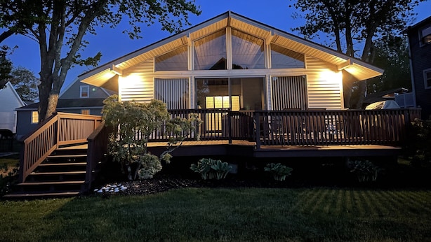 A two-story house with a deck, a staircase, and a large window. - The San'Bar - Great Family Home Just A Short Walk To York's Beautiful Beaches (York)
