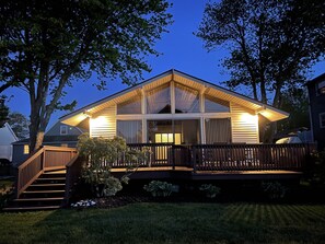 A two-story house with a deck, a staircase, and a large window. - The San'Bar - Great Family Home Just A Short Walk To York's Beautiful Beaches (York)