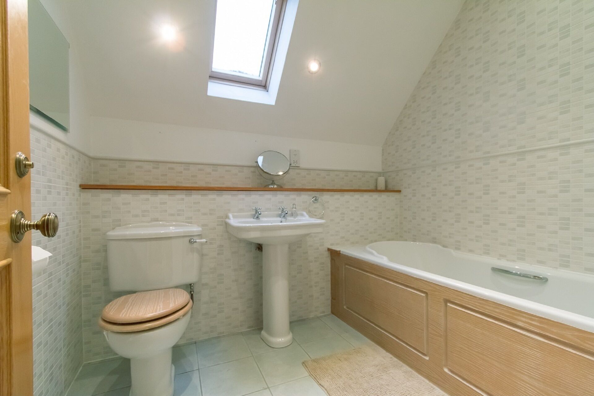 A bathroom with a toilet, sink, and bathtub.