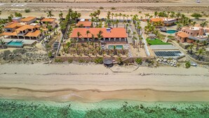 An aerial view of a resort with multiple buildings, a swimming pool, and a beach area. -  Secluded Beach Front Estate with a Large Pool, Family and Pet Friendly!  (Los Barriles)