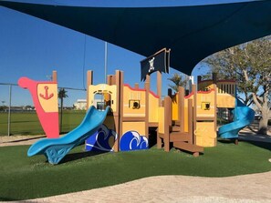 A playground with slides and climbing structures.