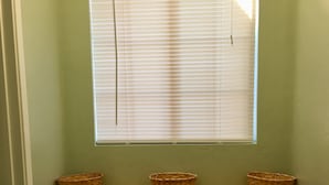 A kitchen with a window above a countertop, three baskets on the counter, and white cabinets below. - 20 minutes from downtown San Diego.Large clean quiet secured studio.Near 54H 125 (Spring Valley)