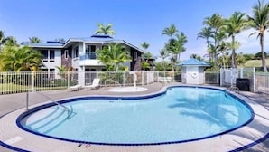 A swimming pool with a circular edge, surrounded by a white fence. -  Spacious, Luxurious, Tropical Townhouse Style Condo For A Truly Aloha Vacation (Kailua-Kona)