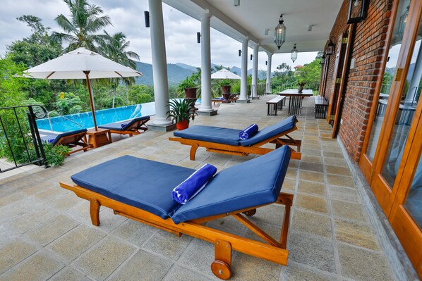 Outdoor pool, open 6:00 AM to 7:00 PM, pool umbrellas, pool loungers