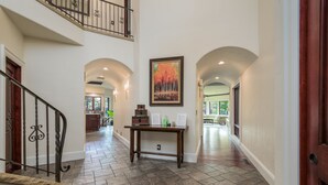 A spacious hallway with a wooden bench, a table with papers, and a painting on the wall. - Bend Waterfront Home: Hot Tub, Walk to Town (Bend)