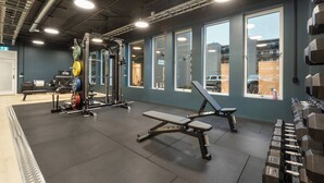 A gym with weightlifting equipment, benches, and a squat rack. - Thon Hotel Partner Mo i Rana (Mo-I-Rana)