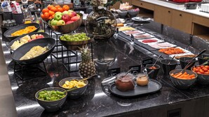 A buffet with various fruits, vegetables, and prepared dishes. - Thon Hotel Partner Mo i Rana (Mo-I-Rana)
