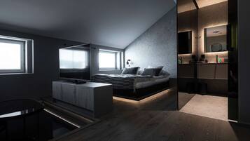 A modern bedroom with a bed, a TV, and a desk.