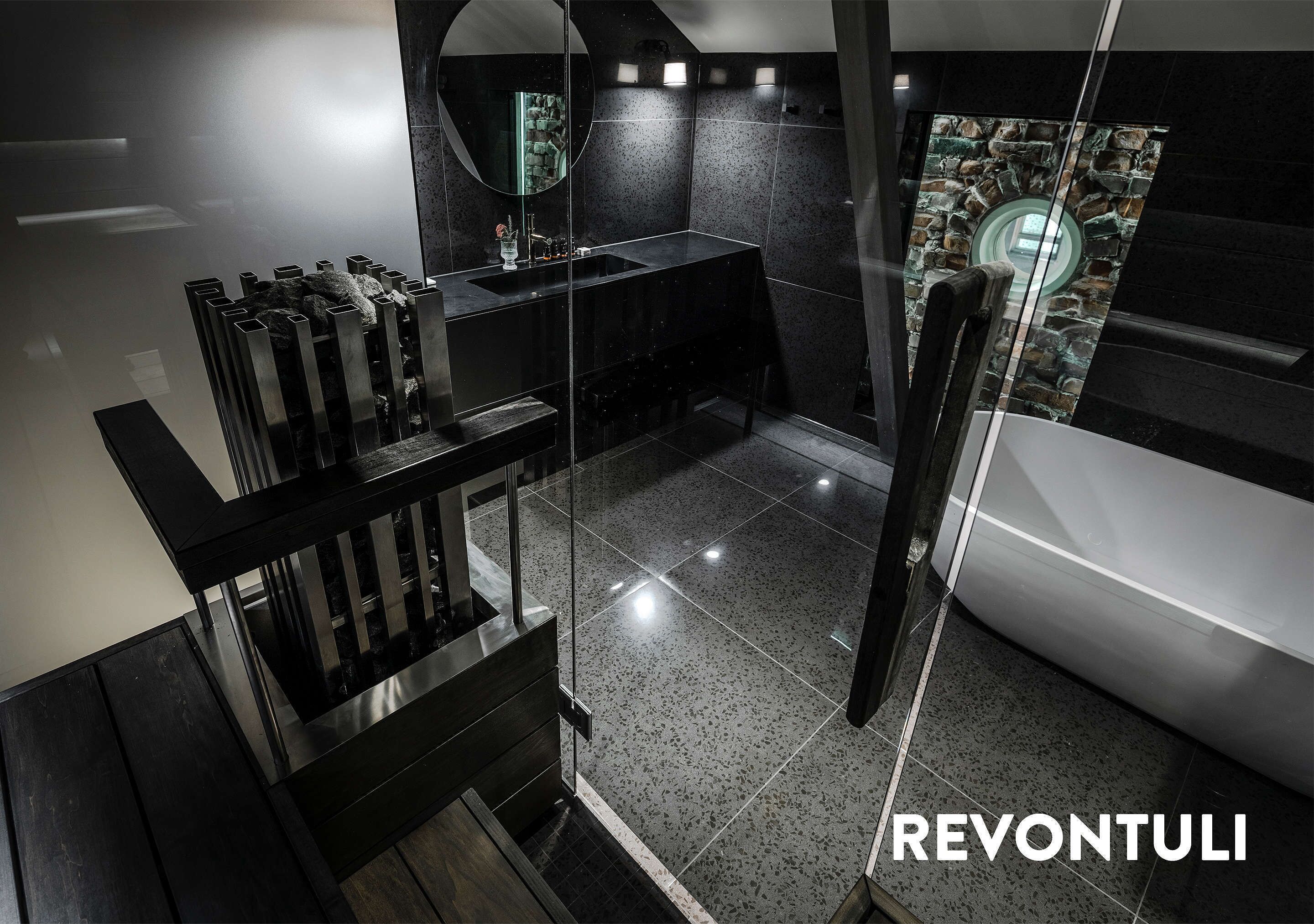 A modern bathroom with a glass shower enclosure, a freestanding bathtub, and a vanity with a mirror.