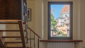 Un escalier offrant une vue sur un bâtiment à travers une fenêtre.