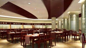 Un restaurante espacioso con varias mesas y sillas, un diseño moderno en el techo y paneles de pared con motivos.
