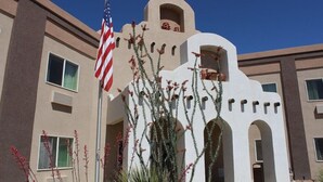A building with a distinctive architectural style, featuring arched windows and a central tower. - Quality INN Alpine (Alpine)