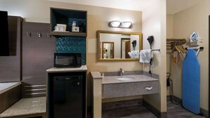 A hotel bathroom with a microwave, sink, and hairdryer. - Quality INN Alpine (Alpine)